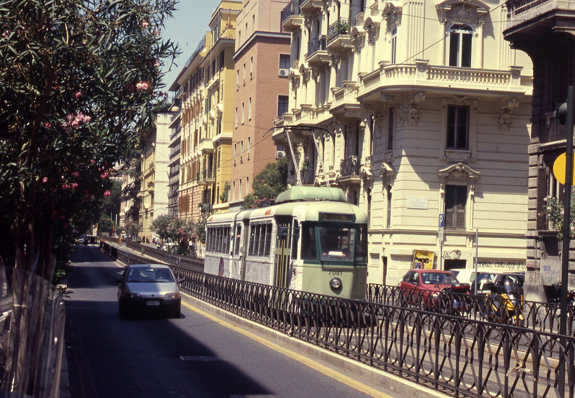 A Rome tram moving through an everyday city street